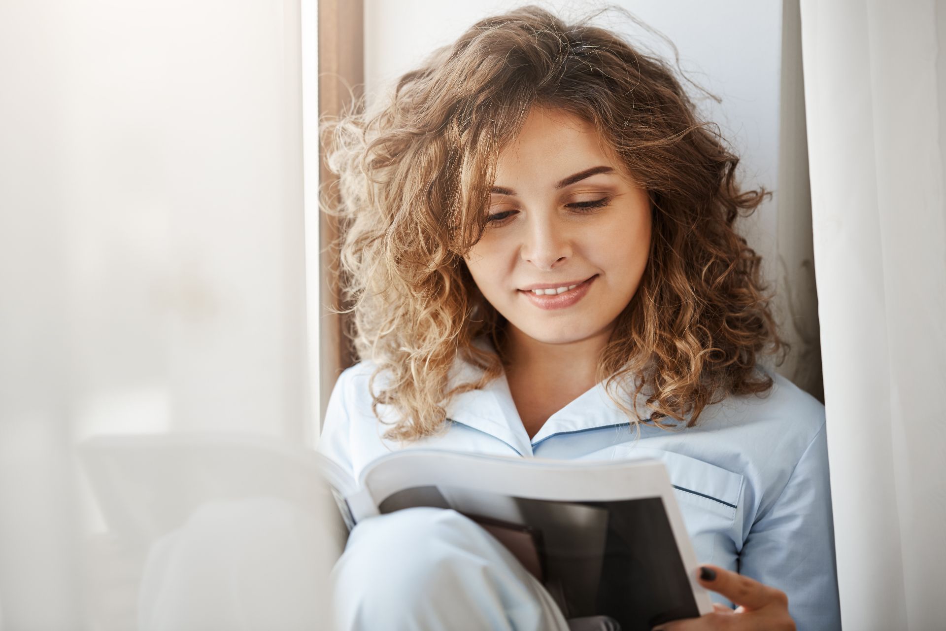 female-sitting-near-window-reading