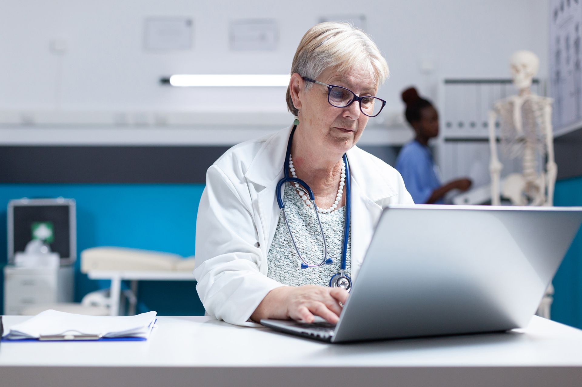 portrait-physician-with-stethoscope-using-laptop-work-healthcare-clinic